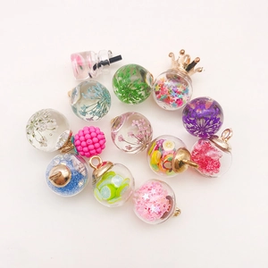 Detailed close-up of mini glass pendants with colorful star sequins and fruit charms
