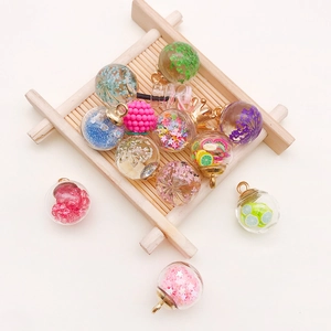 Detail shot of mini glass wishing bottles with colorful sequins and dried flower fillings