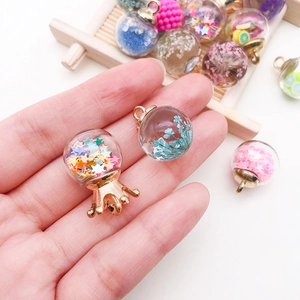 Miniature glass bottle pendants with colorful glitter and dried flower fillings