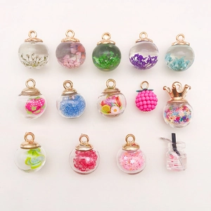 Macro shot of assorted DIY glass bottle pendants with colorful sequins and floral fillings