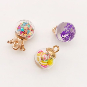 Detail of glass bottle pendants with star sequins, dried flowers and fruit slices