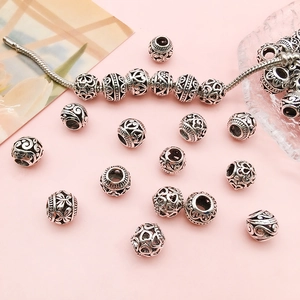Vintage silver hollow charms set with heart and flower patterns for DIY bracelets
