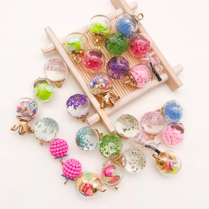 Colorful DIY glass bottle pendants with glitter stars and dried flowers for jewelry