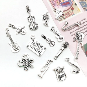 Detailed silver-tone musical instrument charms including guitar, violin, and saxophone