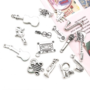 Macro detail of various vintage silver musical instrument charms for DIY jewelry making