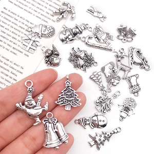 Detailed macro shot of vintage silver Christmas alloy pendants for DIY jewelry making