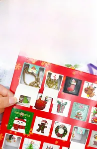 Detailed view of Christmas advent calendar box with golden jewelry and festive charms
