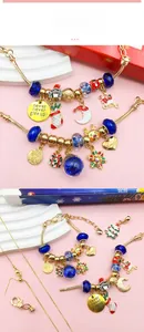 Close-up of Christmas charm bracelet set with blue beads and Santa Claus charms