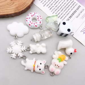 Flat lay of ten assorted resin charms including white bear, rabbit, and duck for DIY crafts
