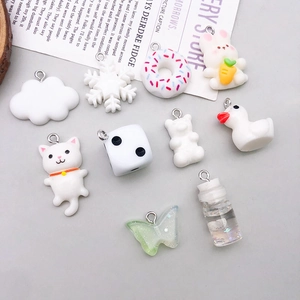 Collection of white resin animal pendants with metal loops for DIY jewelry making