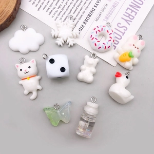 Collection of white resin charms including bears and ducks with silver metal loops for DIY