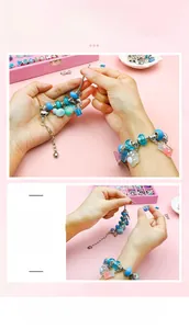 Detail of DIY bracelet set with blue beads and silver charms on pink background