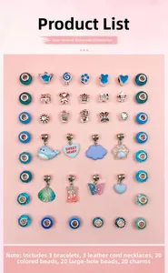 Flat lay of 66pcs blue DIY jewelry set with beads, charms, and necklaces on pink background