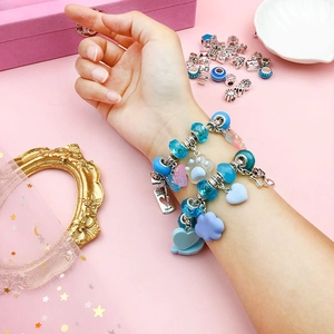 66-piece DIY charm bracelet set featuring blue beads and silver pendants for girls