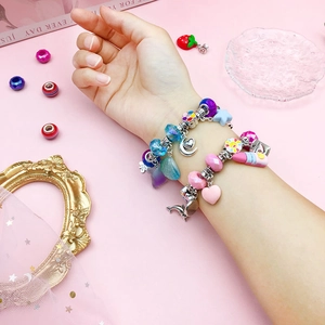 Colorful DIY charm bracelet kit with moon and dolphin pendants in a sweet pink gift set