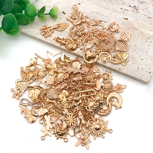 Macro view of assorted gold alloy charms featuring snowman, bee and sun shapes