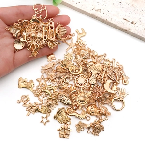 Mix of 100 gold alloy charms in sun, moon and star shapes for DIY jewelry making