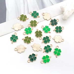Macro shot of colorful enamel four-leaf clover charms with gold metal edges for DIY jewelry