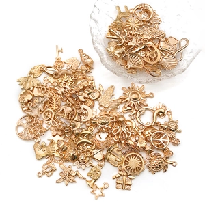 Macro shot of assorted gold alloy charms for DIY jewelry making with diverse celestial shapes