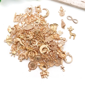 Assorted vintage gold alloy charms in various shapes for DIY jewelry making