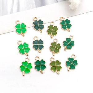 Detailed grid of twelve four-leaf clover alloy charms in various shades of green
