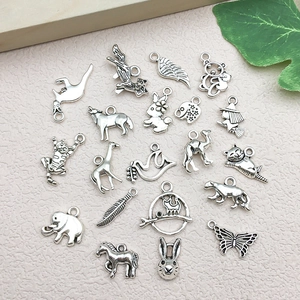 Macro shot of assorted vintage silver animal and plant charms for DIY jewelry making
