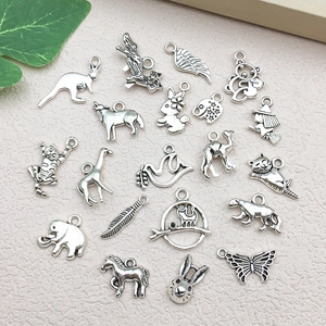 Macro view of assorted antique silver animal charms like elephant, wolf and butterfly