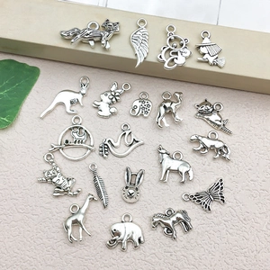 Close-up of antique silver animal charms for DIY jewelry making featuring intricate carving