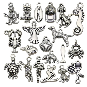 Collection of vintage silver alloy charms with animal and sports themes for DIY jewelry making