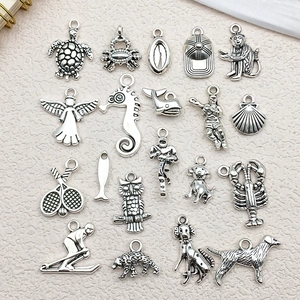 Detailed macro view of vintage silver animal and sports alloy pendant charms