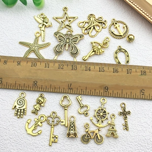 Gouden bedeltjes set met zeester, vlinder en sleutel vormen voor DIY sieraden maken