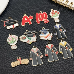 Detailed DIY graduation charms featuring alloy doctoral caps and colorful diplomas