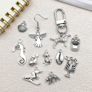 Collection of vintage silver alloy charms featuring seahorse shell and animal shapes