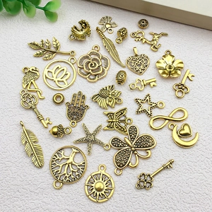 Detailed collection of vintage gold alloy butterfly and leaf charms for DIY jewelry making