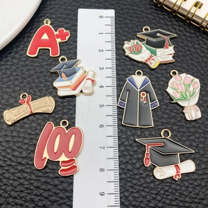 DIY graduation enamel charms set featuring caps and books for necklaces and keychains