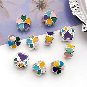 Macro detail of enamel flower and butterfly charms for DIY jewelry making sets