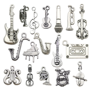 Vintage silver musical instrument charms set including guitar, violin, and saxophone