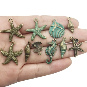 Vintage ocean-themed bronze alloy charms featuring starfish, seahorse, and seashells