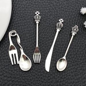 Vintage silver alloy crown cutlery charms including knife fork and spoon pendants