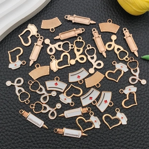 Macro detail of medical charms including stethoscopes and syringes on black leather background