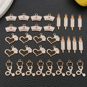 Detail of medical charms including syringe and stethoscope for DIY jewelry making