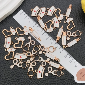 DIY medical alloy charms set featuring nurse hat, syringe, and heart on leather background