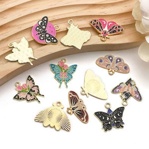 Detailed macro view showing butterfly enamel charms with golden textured metal backing