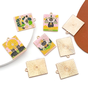 Détail de pendentifs tarot chat noir montrant les motifs du Mat et de la Justice