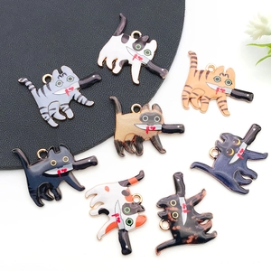 Detail of 8 cartoon cat charms with knives for DIY jewelry making and keychains