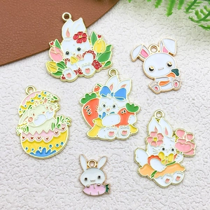 Detailed view of six DIY enamel rabbit charms with colorful easter egg and carrot motifs