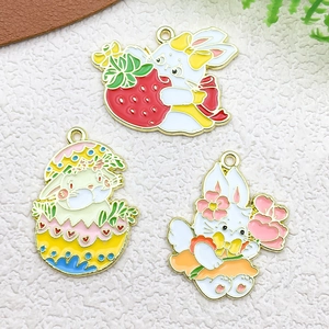 Detailed macro of gold plated enamel Easter bunny charms for DIY jewelry making