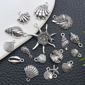 Macro shot of assorted ocean theme charms including starfish and shells for DIY jewelry making