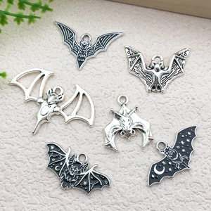Detailed view of assorted alloy bat pendants with hollow out and black oil drip patterns