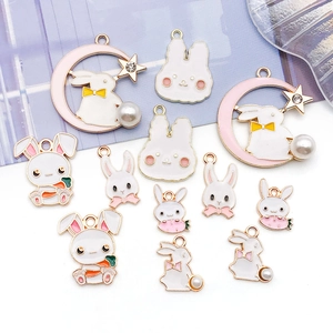 Detailed view of DIY bunny charms with faux pearls and rhinestones for handmade jewelry